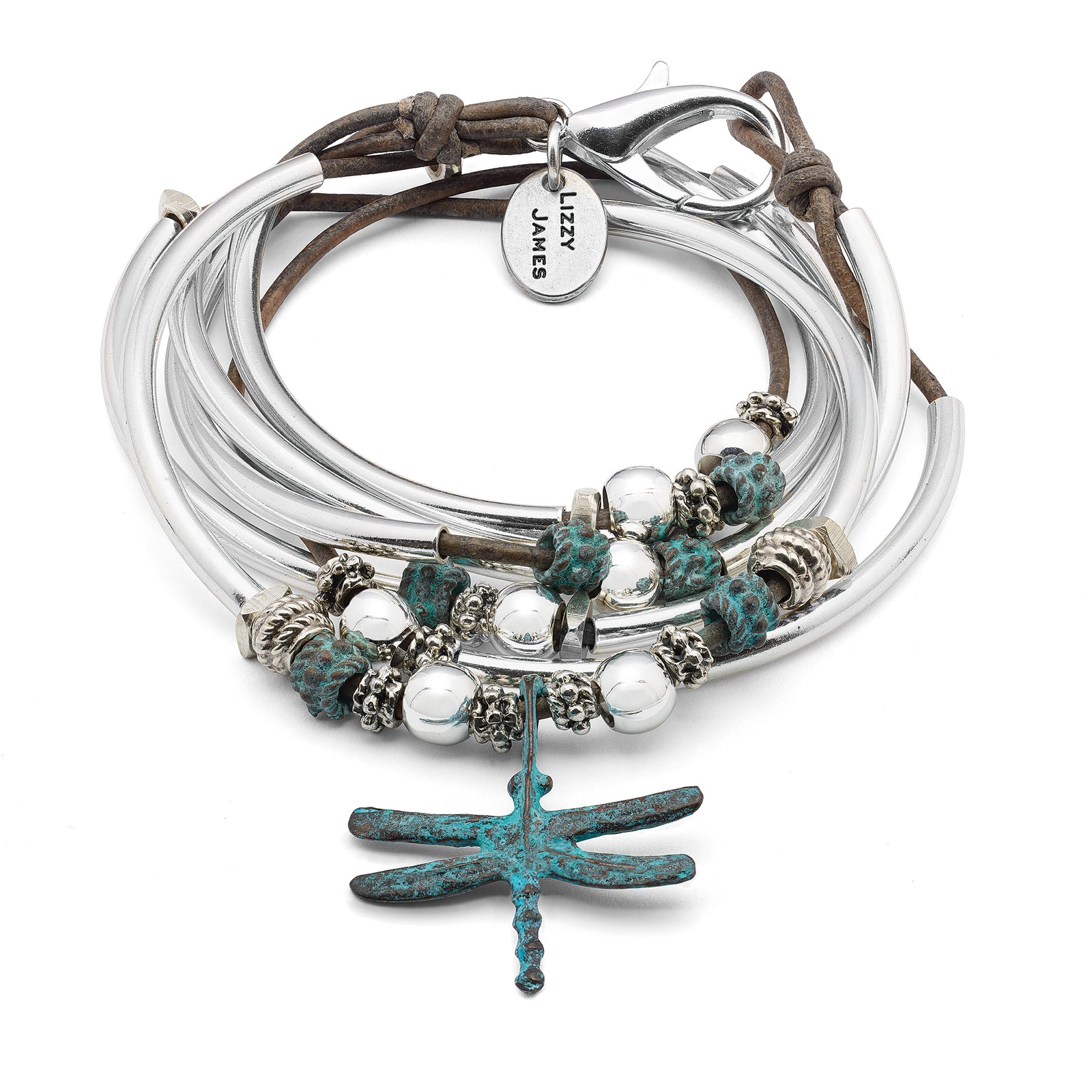 Close-up of a wrist wearing multiple silver bracelets with beads on a denim background