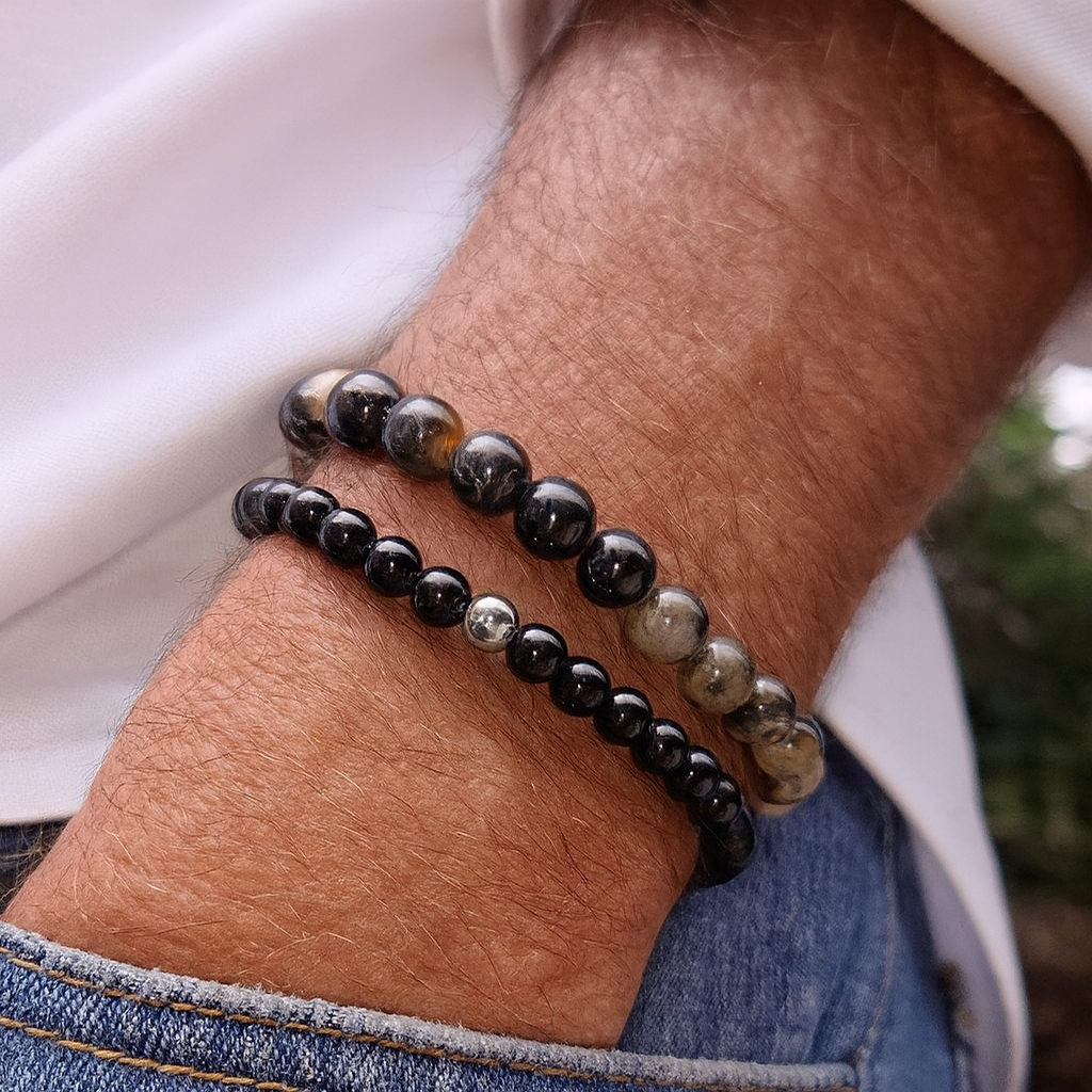 Black beaded bracelet on a wrist with a blurred background