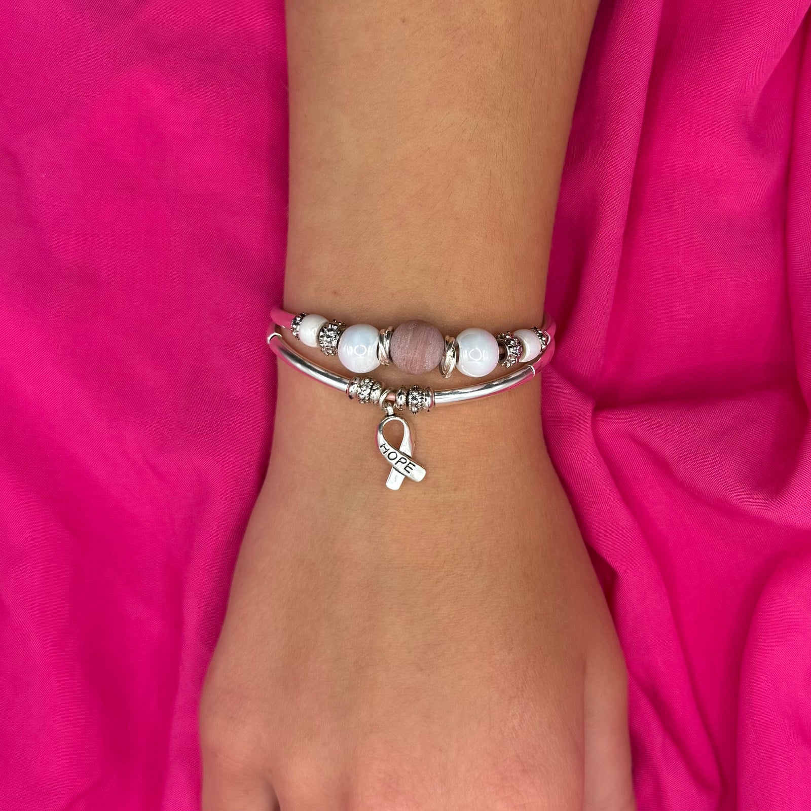 Bracelet with beads and 'hope' charm on a white background