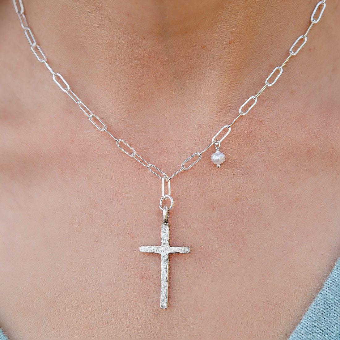 Lizzy James Adina simple and dainty silver cross pendant necklace with a petite pearl. Elegant everyday jewelry.