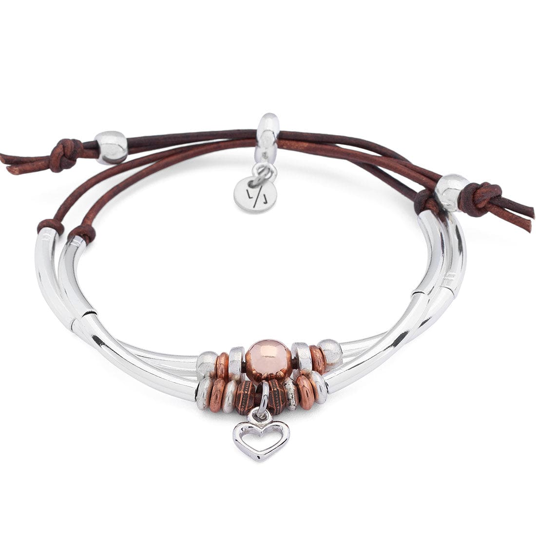 Close-up of a wrist wearing a silver and rose gold bracelet on a blurred background