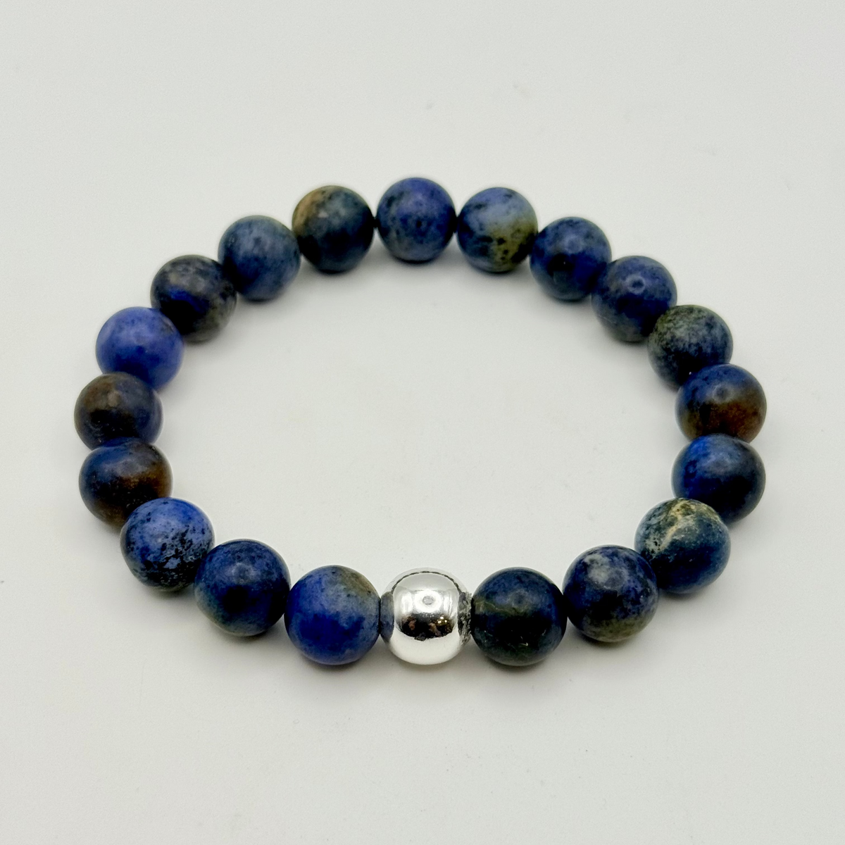 Studio photo of a 10MM Matte Finish Soladite Gemstone bracelet with sterling silver accent bead
