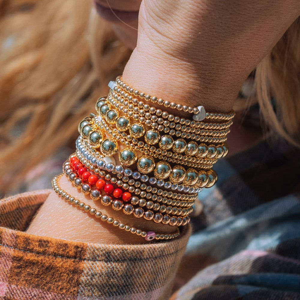  14k gold-filled bracelet stack with red coral and sterling silver bracelets