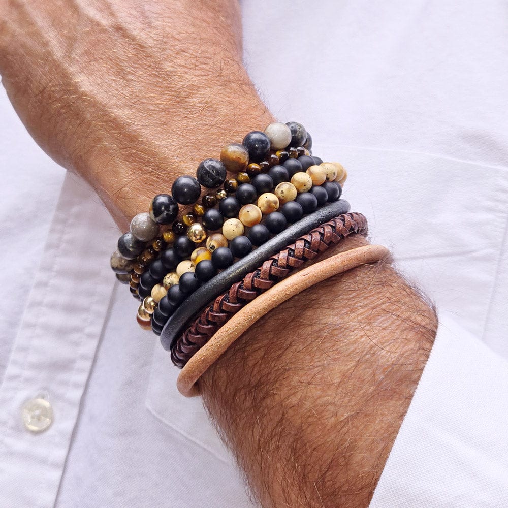 Two men&#39;s black onyx bracelets stacked with tiger&#39;s eye, agate bead, and three leather bracelets