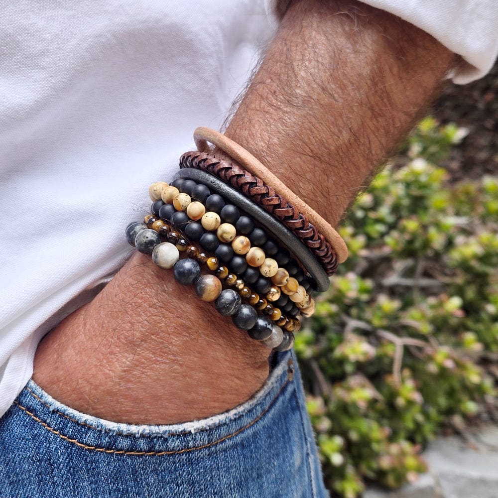 Two men&#39;s black onyx bracelets stacked with tiger&#39;s eye, agate bead, 14k gold beads, and three thick leather bracelets