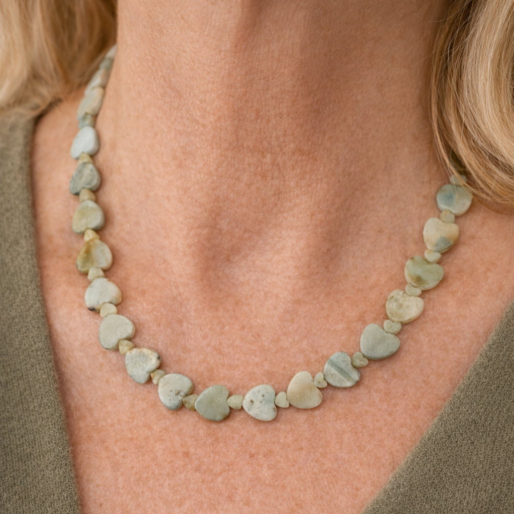 Adjustable 16 to 18 inch necklace with a mix of large and small light teal Amazonite heart-shaped gemstones and a silver clasp.