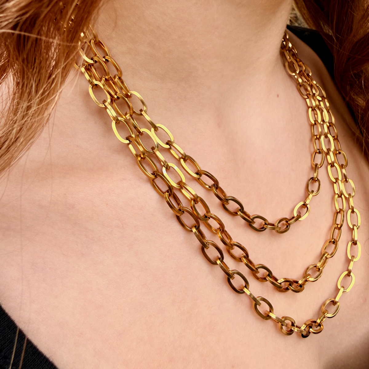Gold chain necklace on a person's neck