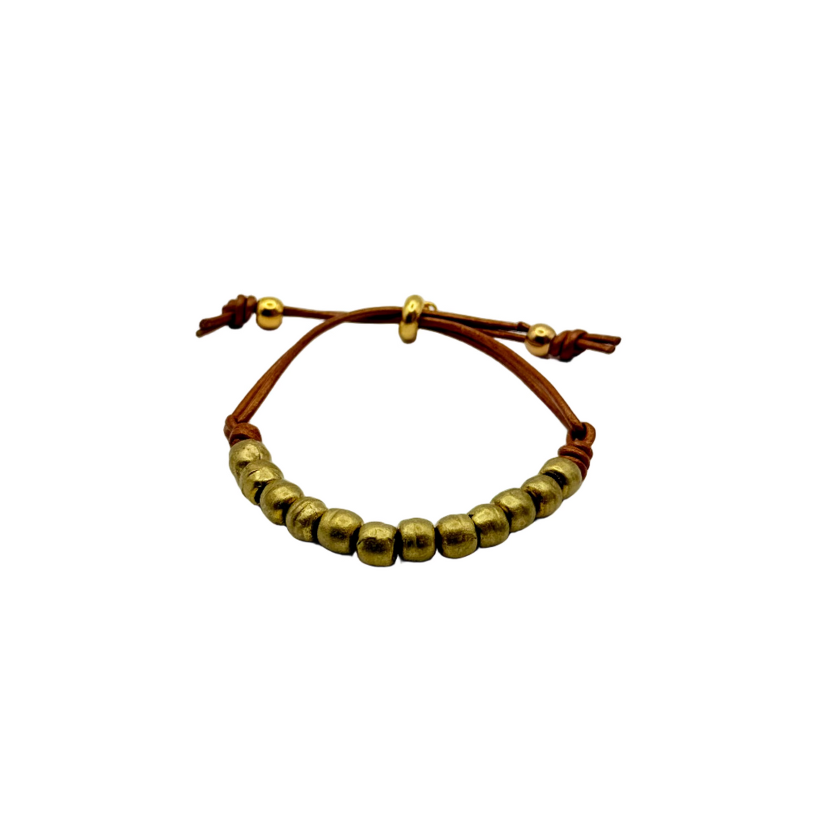 Bracelet with gold beads and brown leather strap on a white background