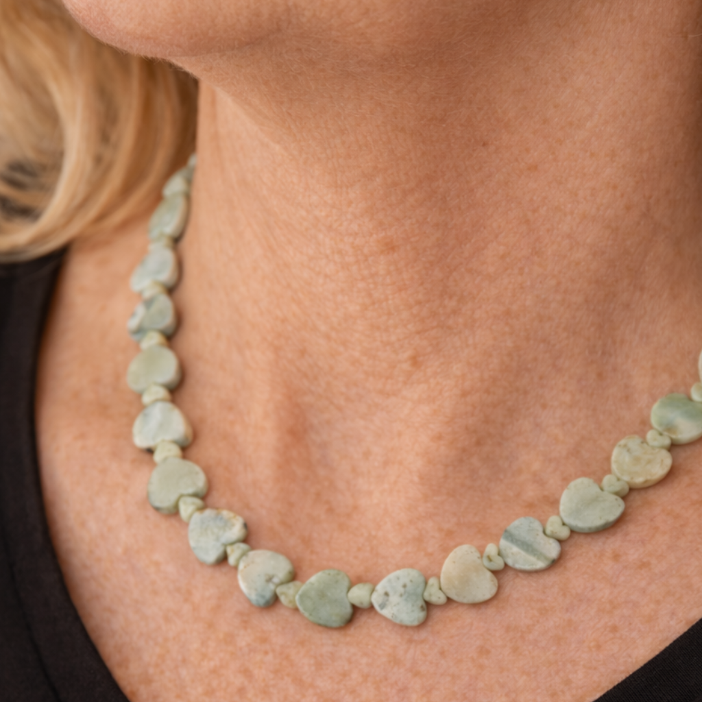 Adjustable 16 to 18 inch necklace with a mix of large and small light teal Amazonite heart-shaped gemstones and a silver clasp.