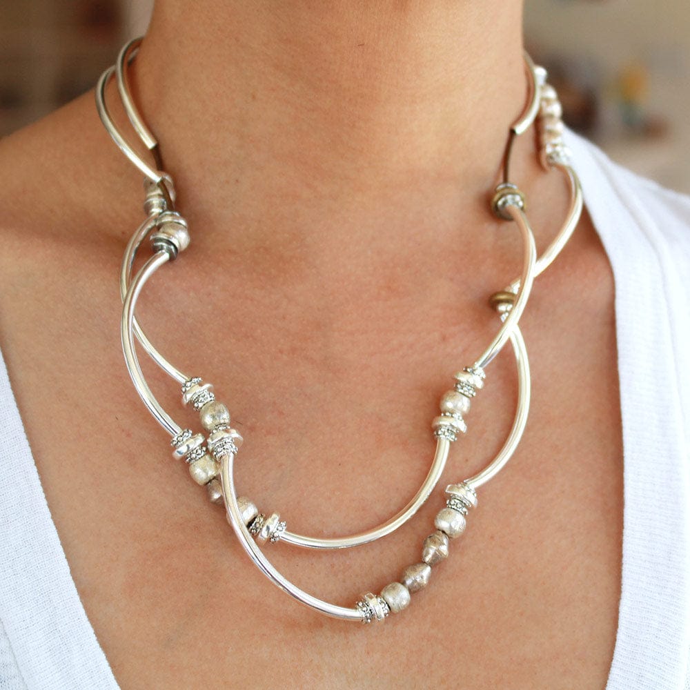 Person wearing the Bella Metallic Bronze Leather Wrap Bracelet with Silver & Mixed Metal Beads