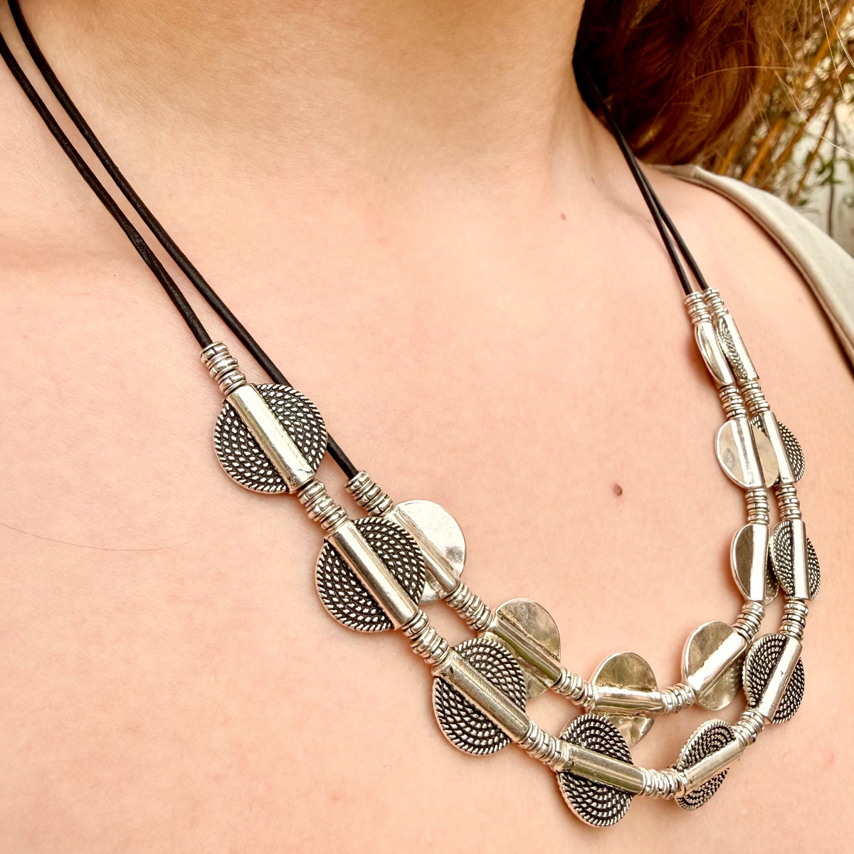 Vesper black leather 2-tier The Vesper Layers 2-tier black leather necklace with silver-plate textured disks and round beads.