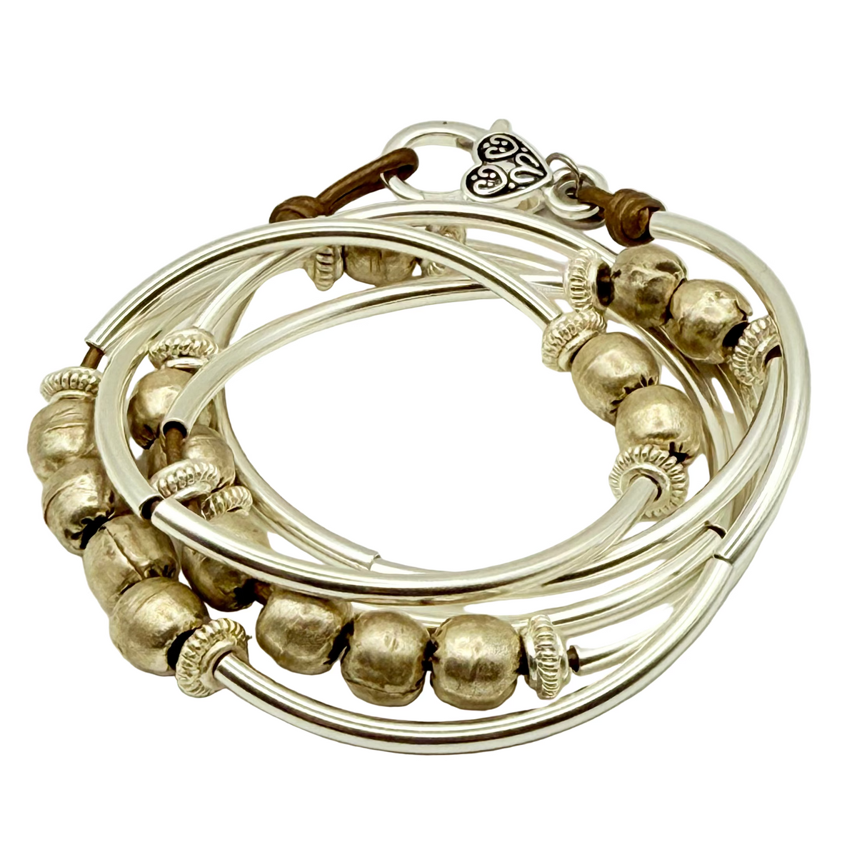 Set of silver and gold bangles on a light gray background