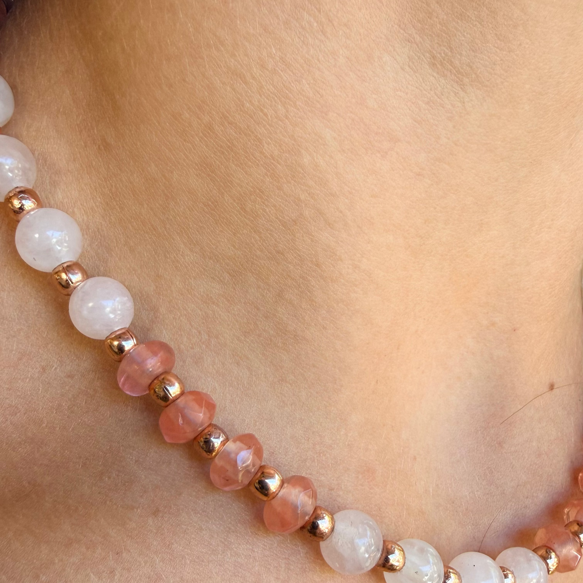 Pink Celia Quartz Necklace with rose quartz and rose gold accents worn at the neckline