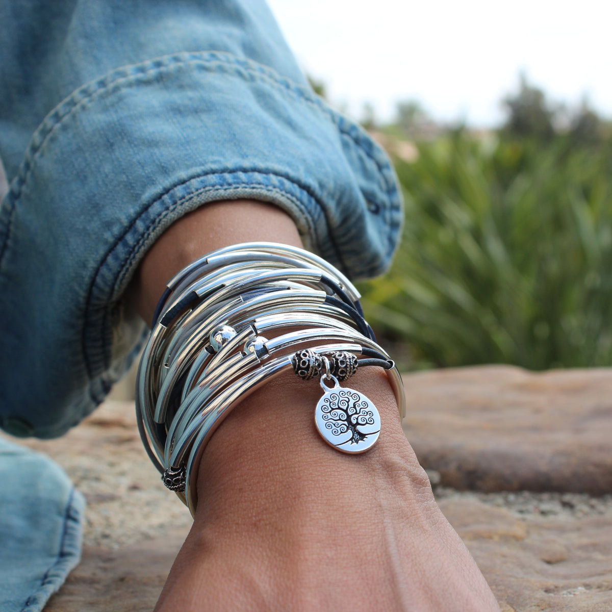 Leather wrap bracelet with silver crescents and accent beads with a tree of life charm attached