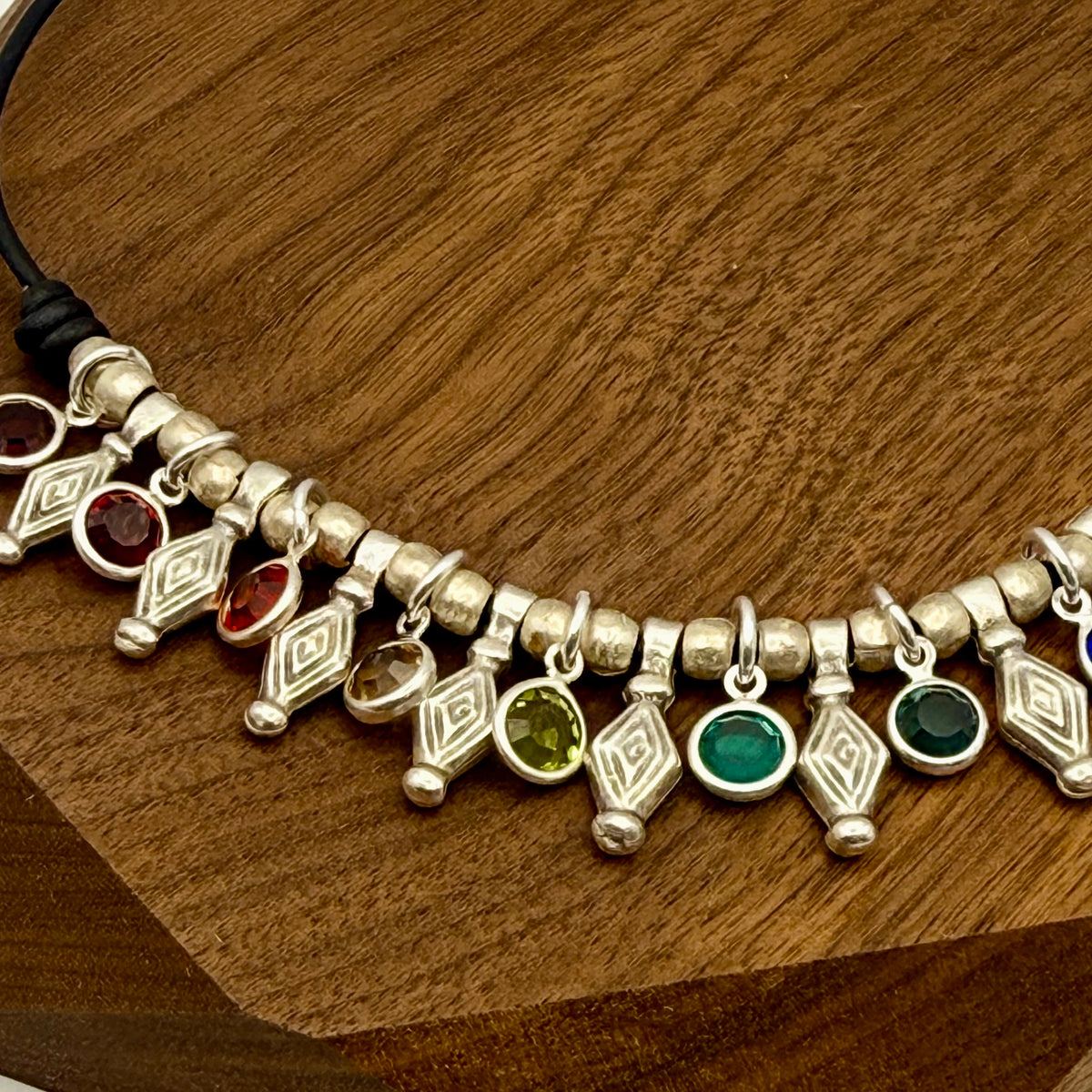 Antique Silver metal beads strung on black leather with multi-colored crystal charms