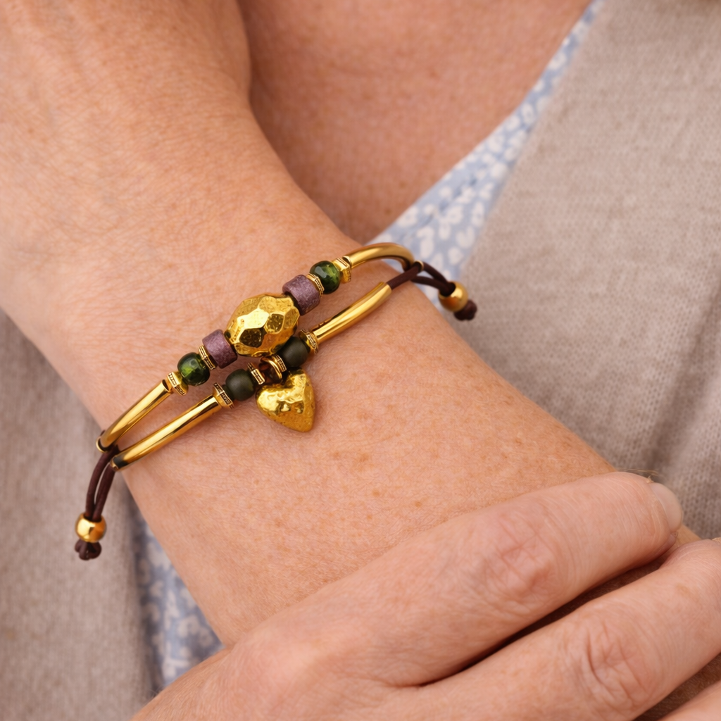 Close-up of a wrist wearing a gold and brown beaded bracelet.