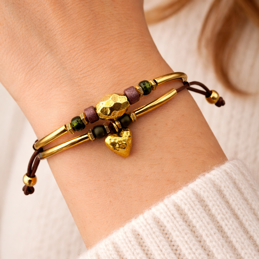 Gold and brown beaded bracelet on a wrist with a blurred background