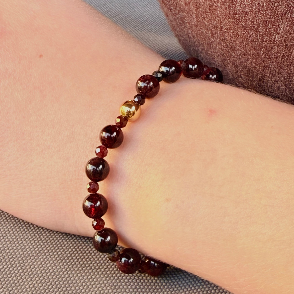 Beaded bracelet on a wrist with a neutral background