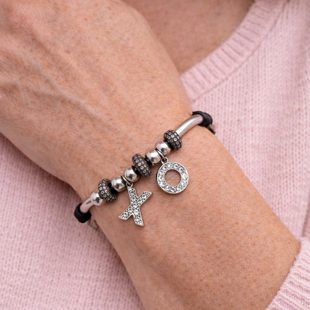 Women's black leather bracelet with silver XO charms, silver-tone beads, and pavé crystal accents.