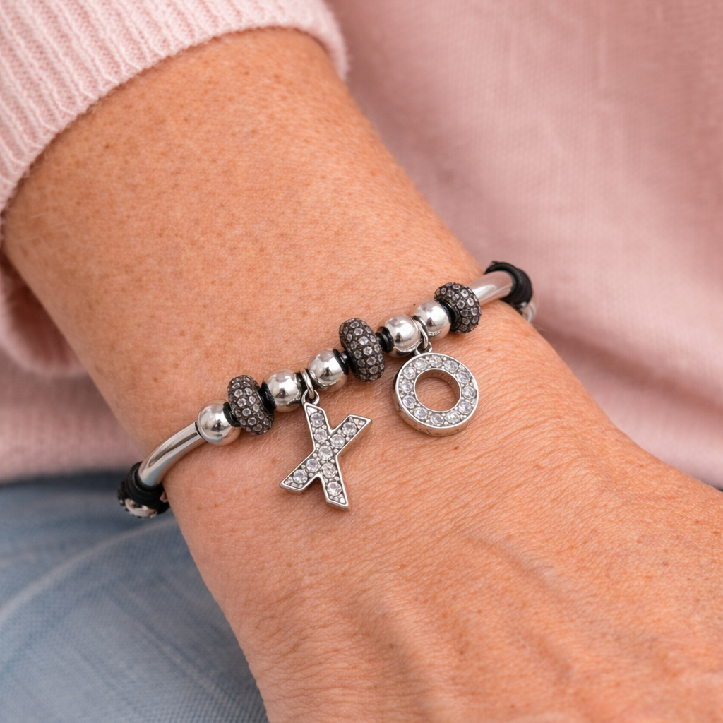 Women's black leather bracelet with silver XO charms, silver-tone beads, and pavé crystal accents.