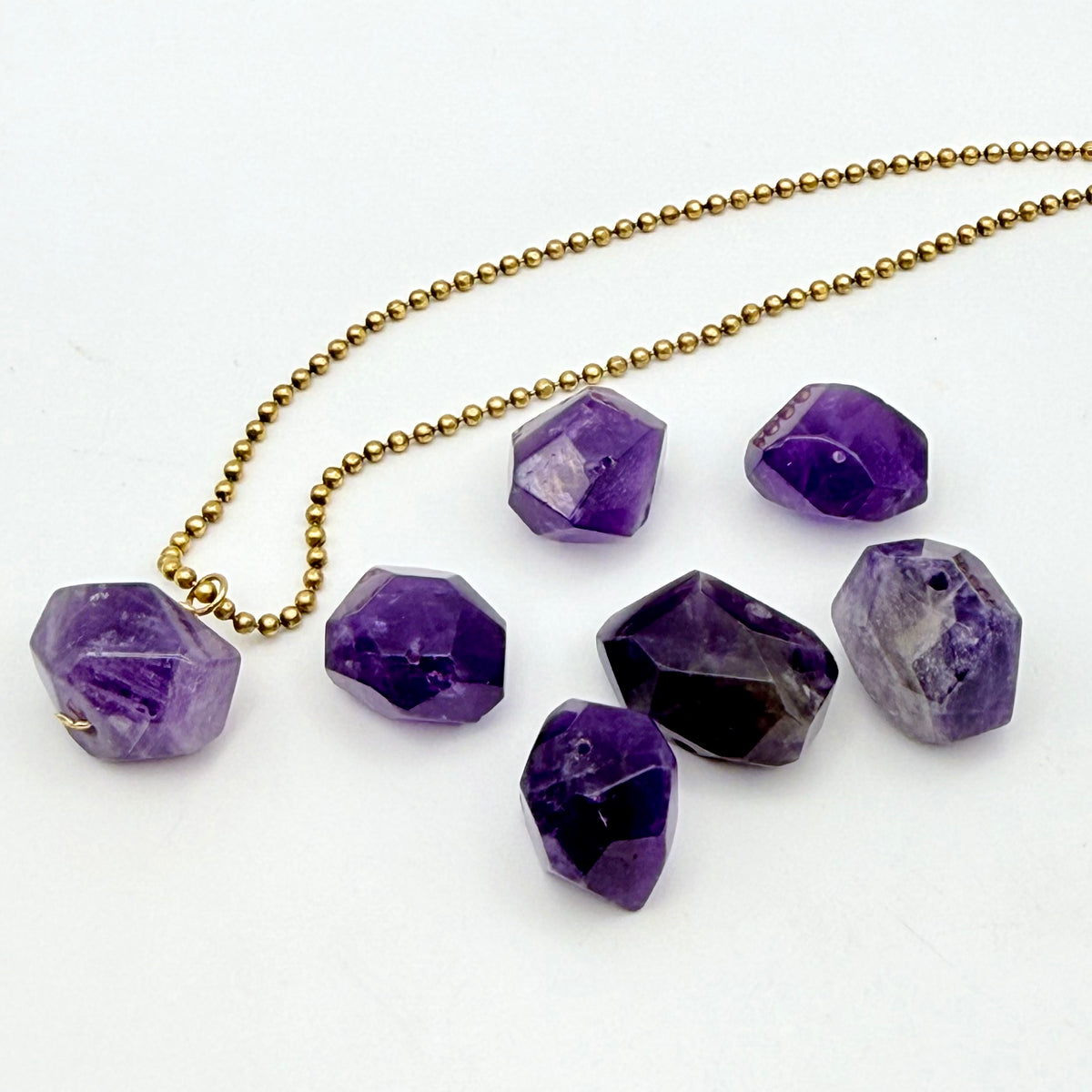 Necklace with purple gemstones on a white background