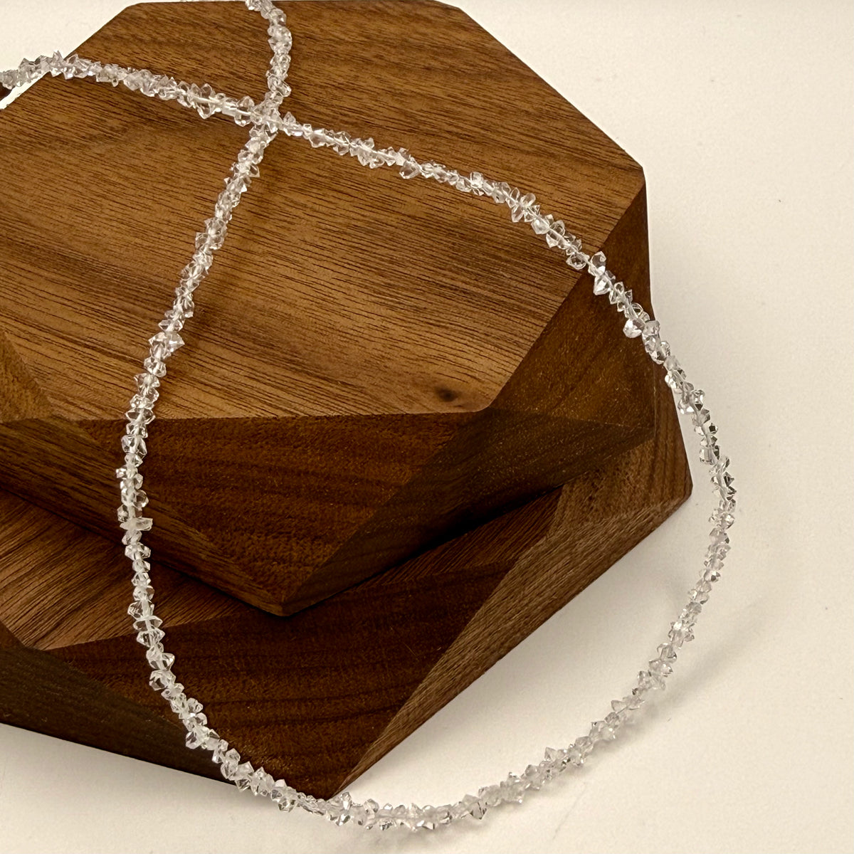 Crystal necklace on a wooden hexagonal block