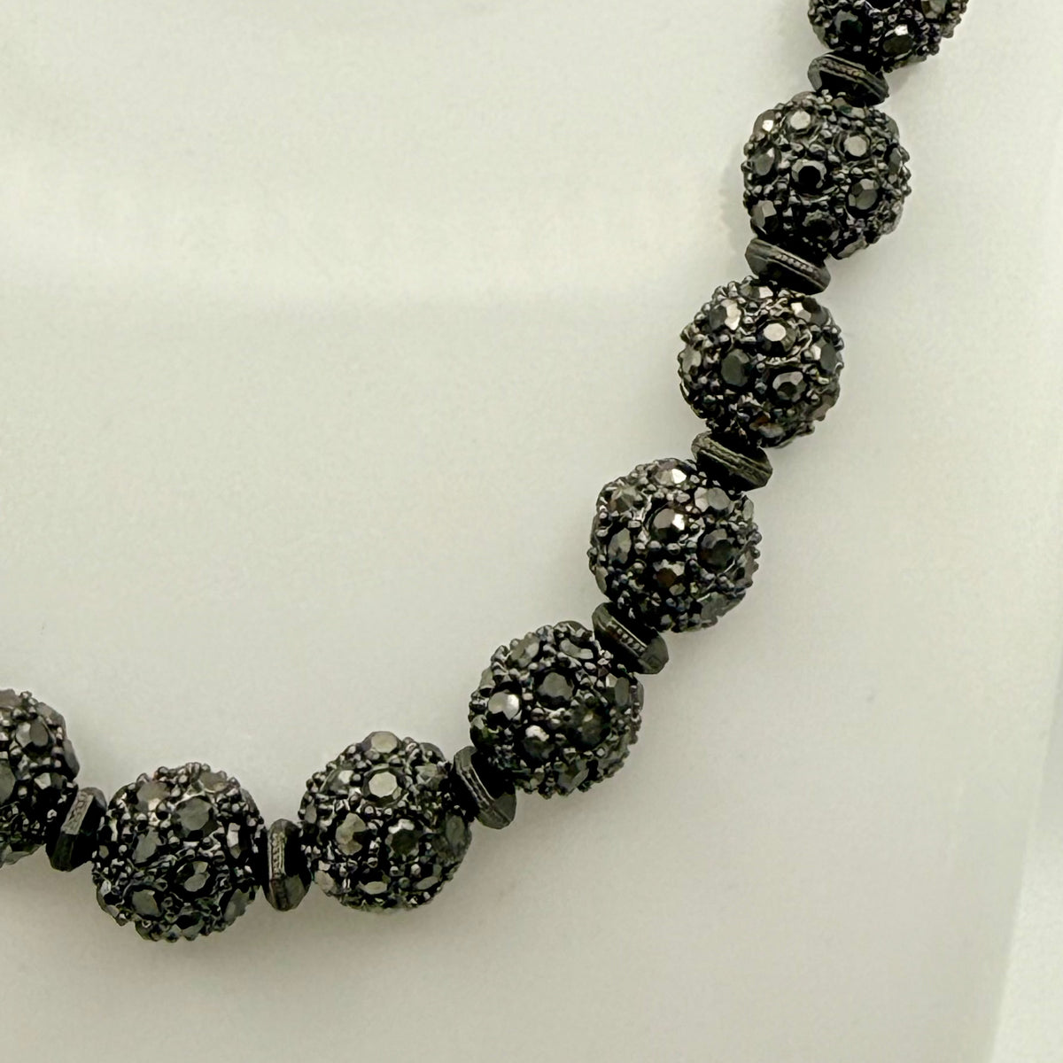 Necklace with black beaded design on a white background