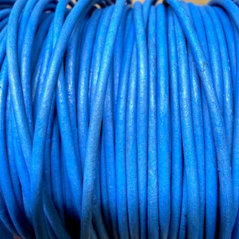 Coiled blue cable on a wooden surface