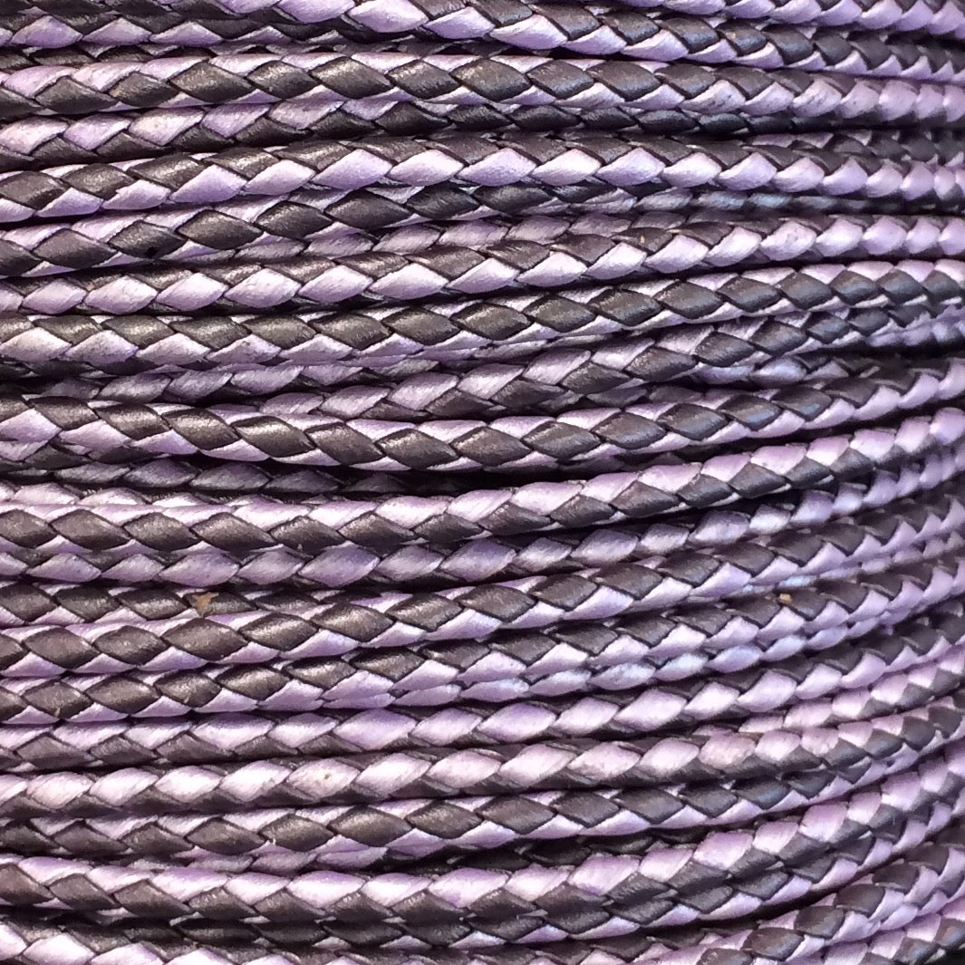 A close-up of braided cord or rope in a purple and dark gray colorway, showing the detailed texture of the woven pattern.