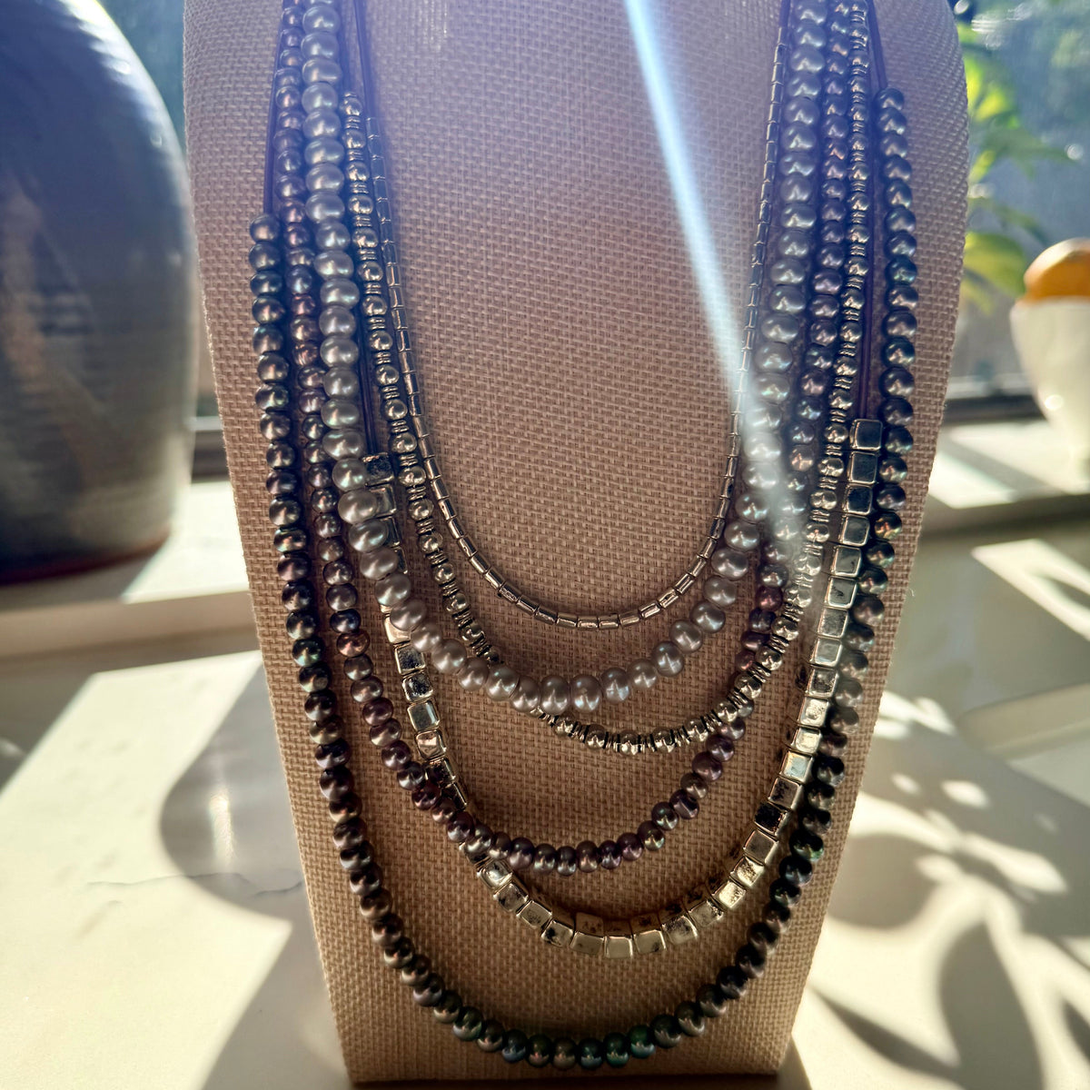 Necklace on a mannequin bust with a blurred background