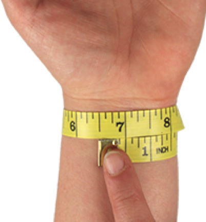 A close-up of a hand and wrist wearing a yellow measuring tape wristband with black measurement markings and a metal clasp being adjusted by a finger, on a white background.