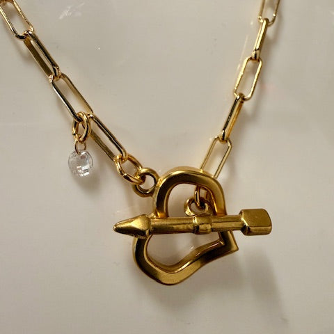 Gold necklace with a unique clasp design on a white background