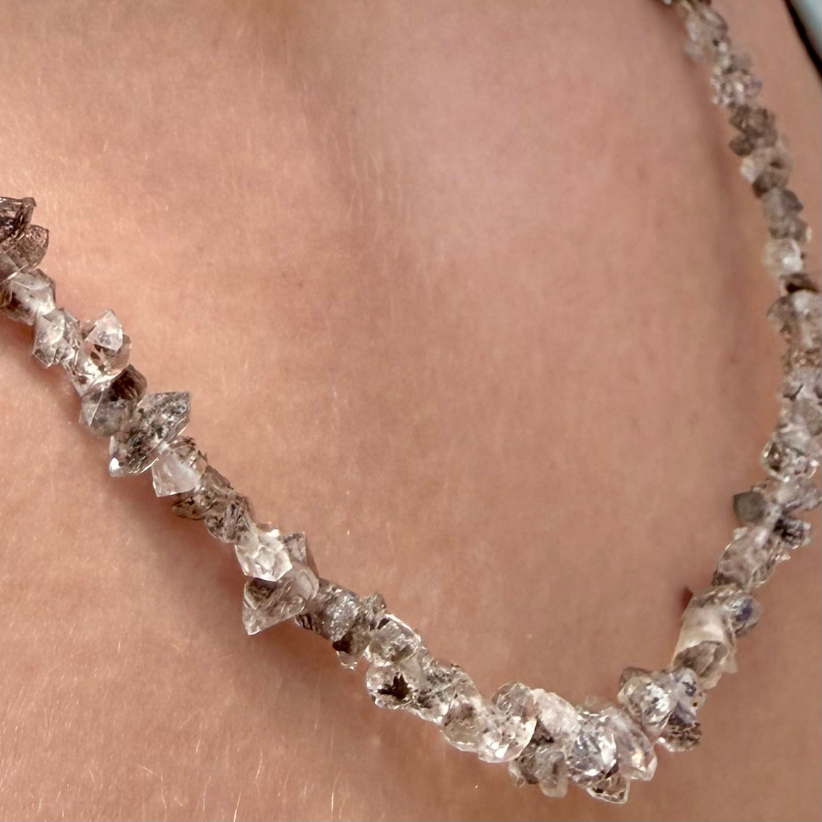 Necklace with raw diamond beads on a person's neck