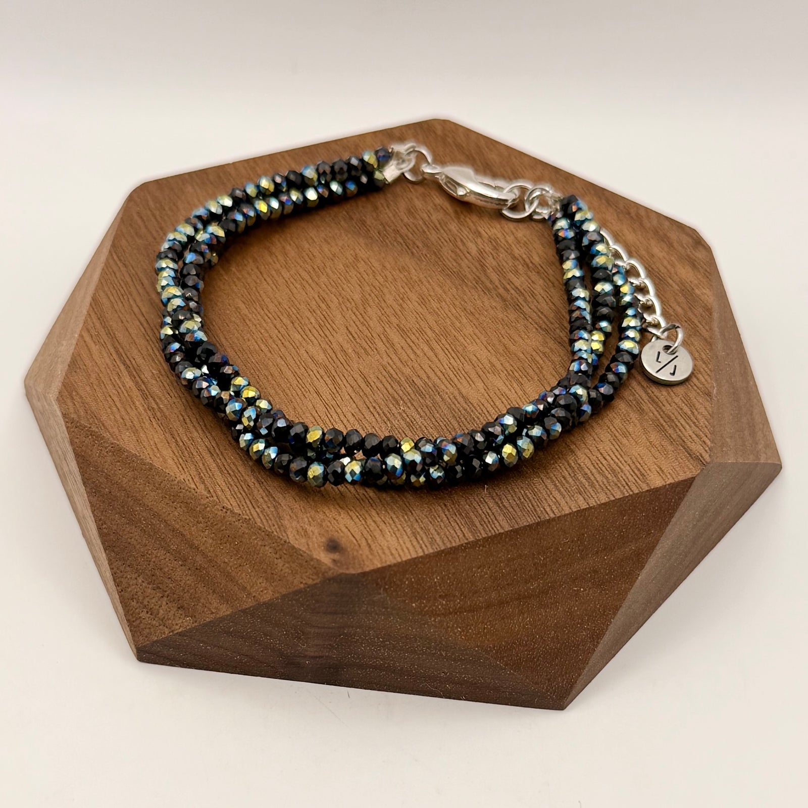 Multistrand beaded bracelet on a wrist with a denim background