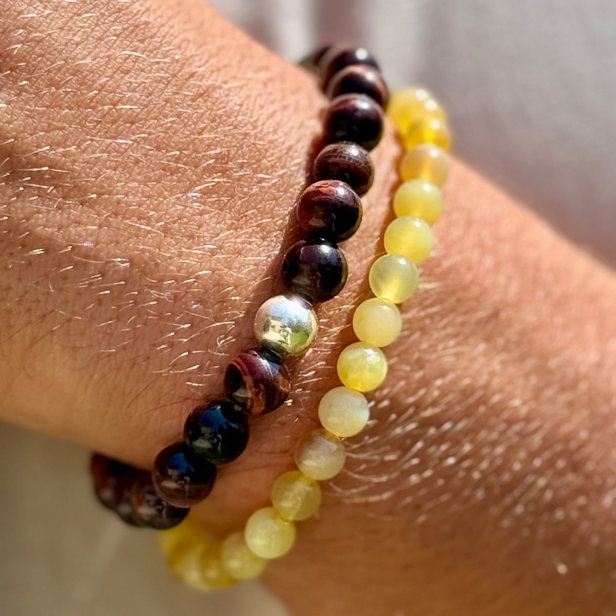Close-up of a wrist wearing a beaded bracelet with multicolored beads.