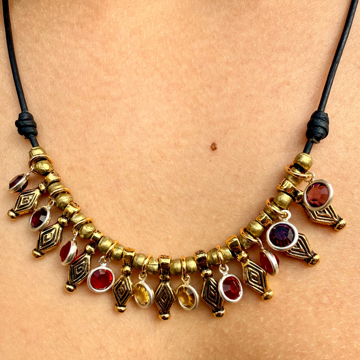 Necklace with gold and red beads on a person's neck