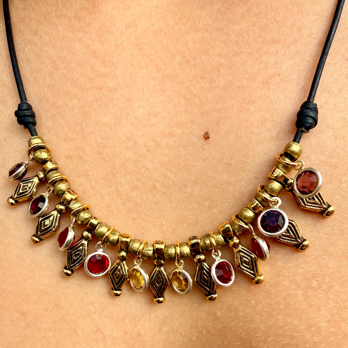 Necklace with gold and red beads on a person's neck