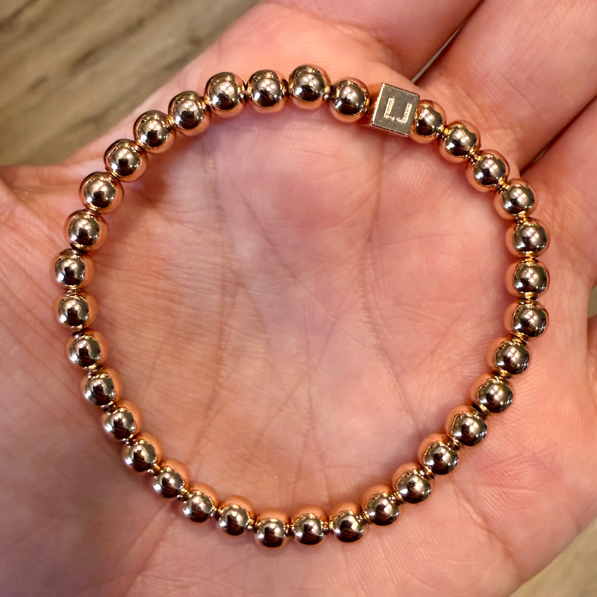 Polished 5mm rose gold-plated bead stretch-to-fit bracelet with a signature LJ accent bead for women.