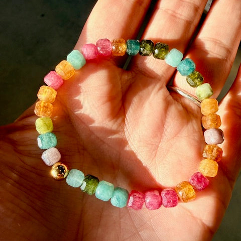 Colorful beaded bracelet on a hand with a blurred background