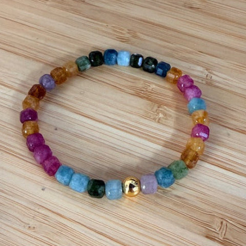 Multicolored beaded bracelet on a wooden surface