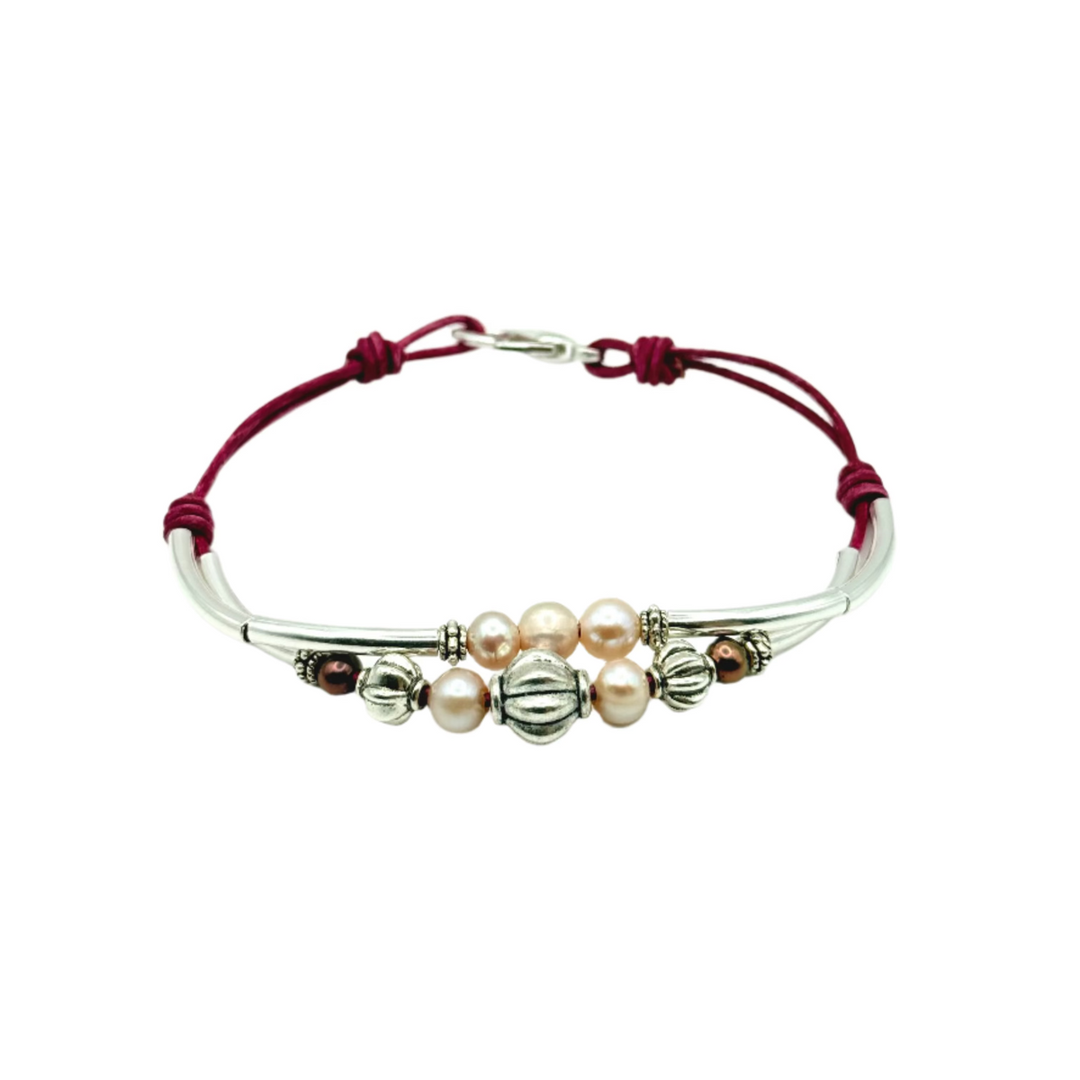 Bracelet with pearls and pink cord on a white background