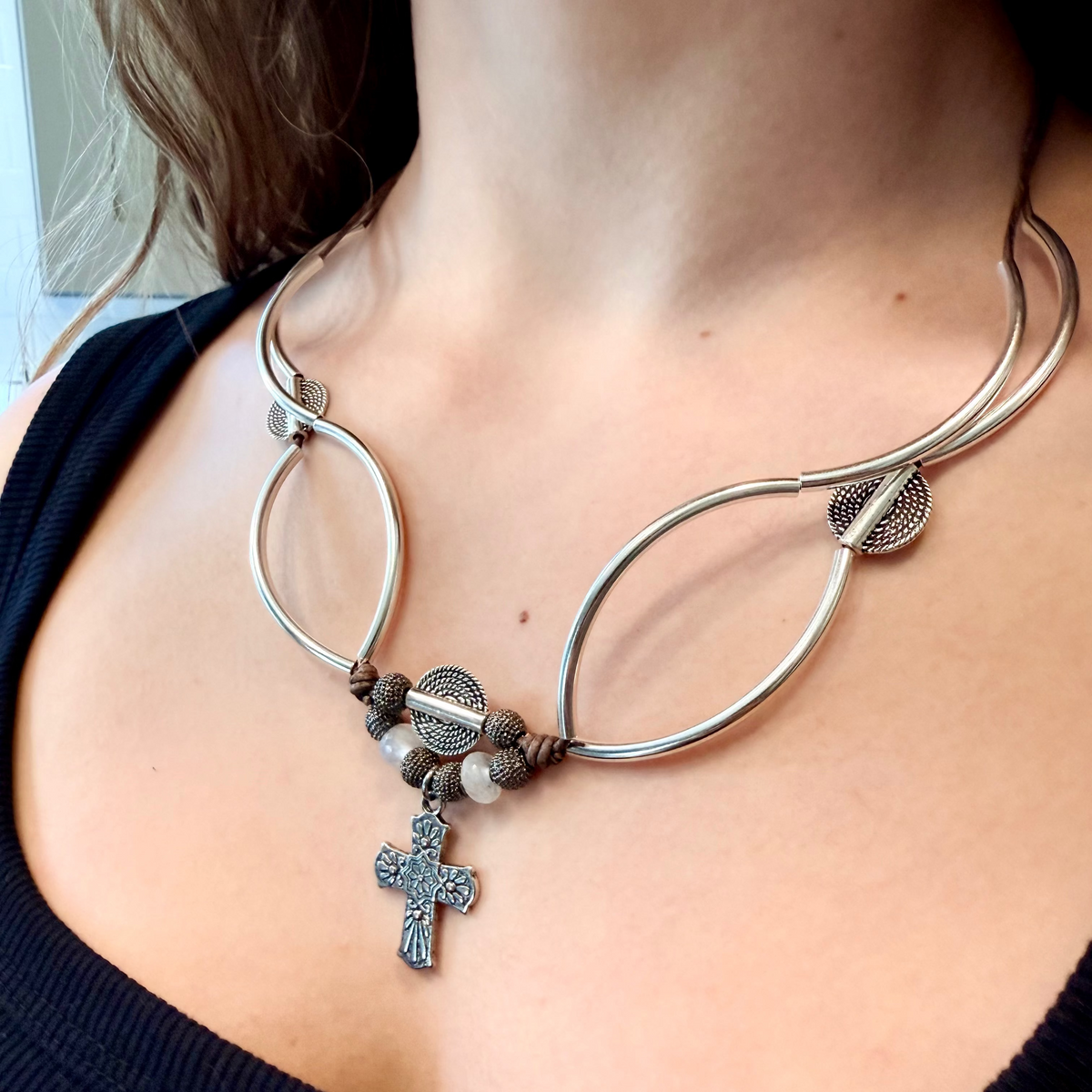 Selene convertible brown leather cross necklace with moonstone beads that wraps into a layered bracelet.
