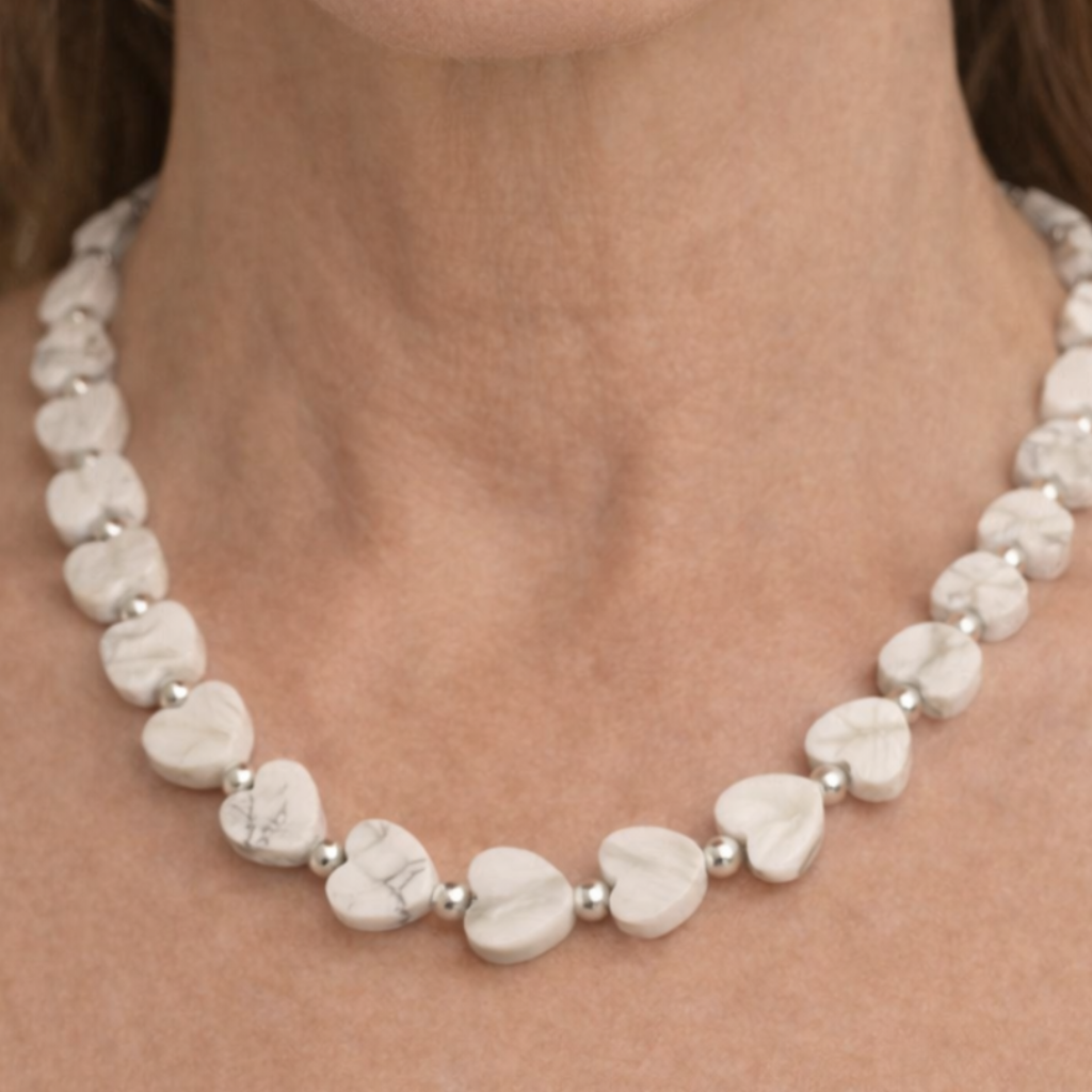Howlite Heart Gemstone Necklace with Sterling Silver Beads around a womans neck