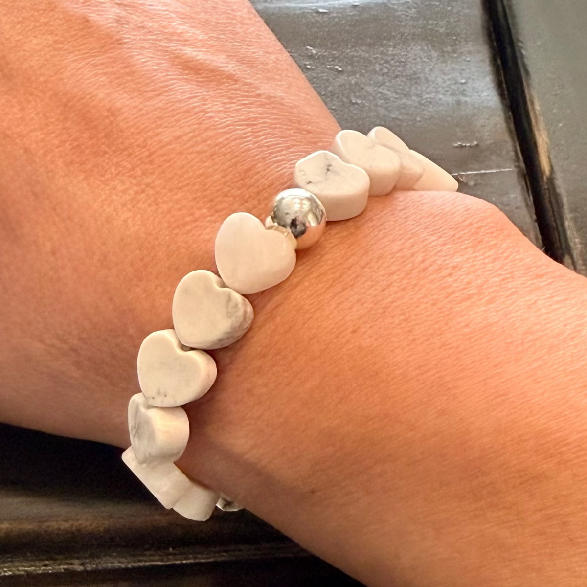 Howlite Heart Stretch-to-Fit Bracelet with one silver accent bead on womans wrist