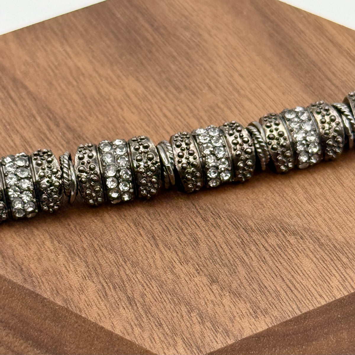 Silver beaded bracelet on a wooden surface