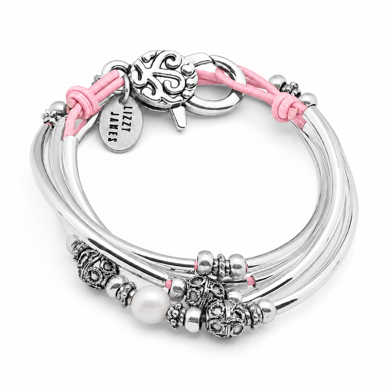 Leather wrap bracelet with pink leather, silver crescents and bead accessnts and a pearl focal.