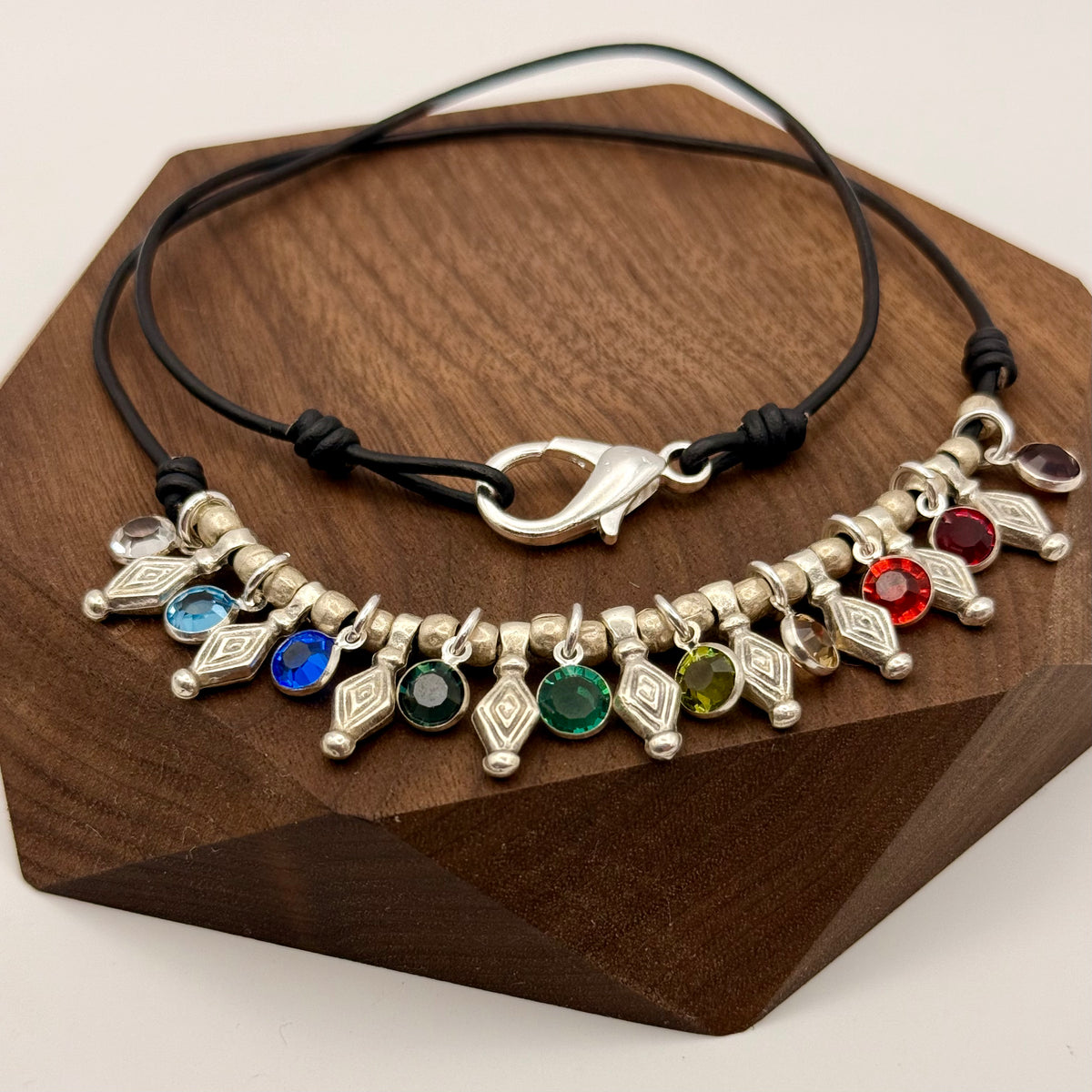 Necklace with colorful gemstones on a wooden stand