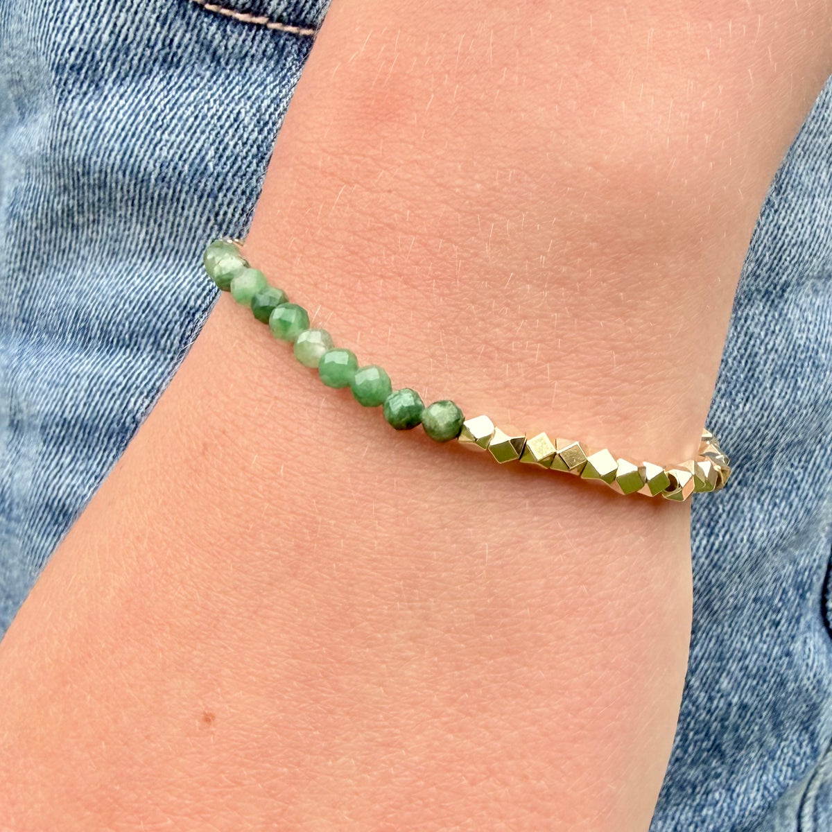 Detail of faceted emerald gemstone beads and gold-filled hexagon accents on Elowen bracelet