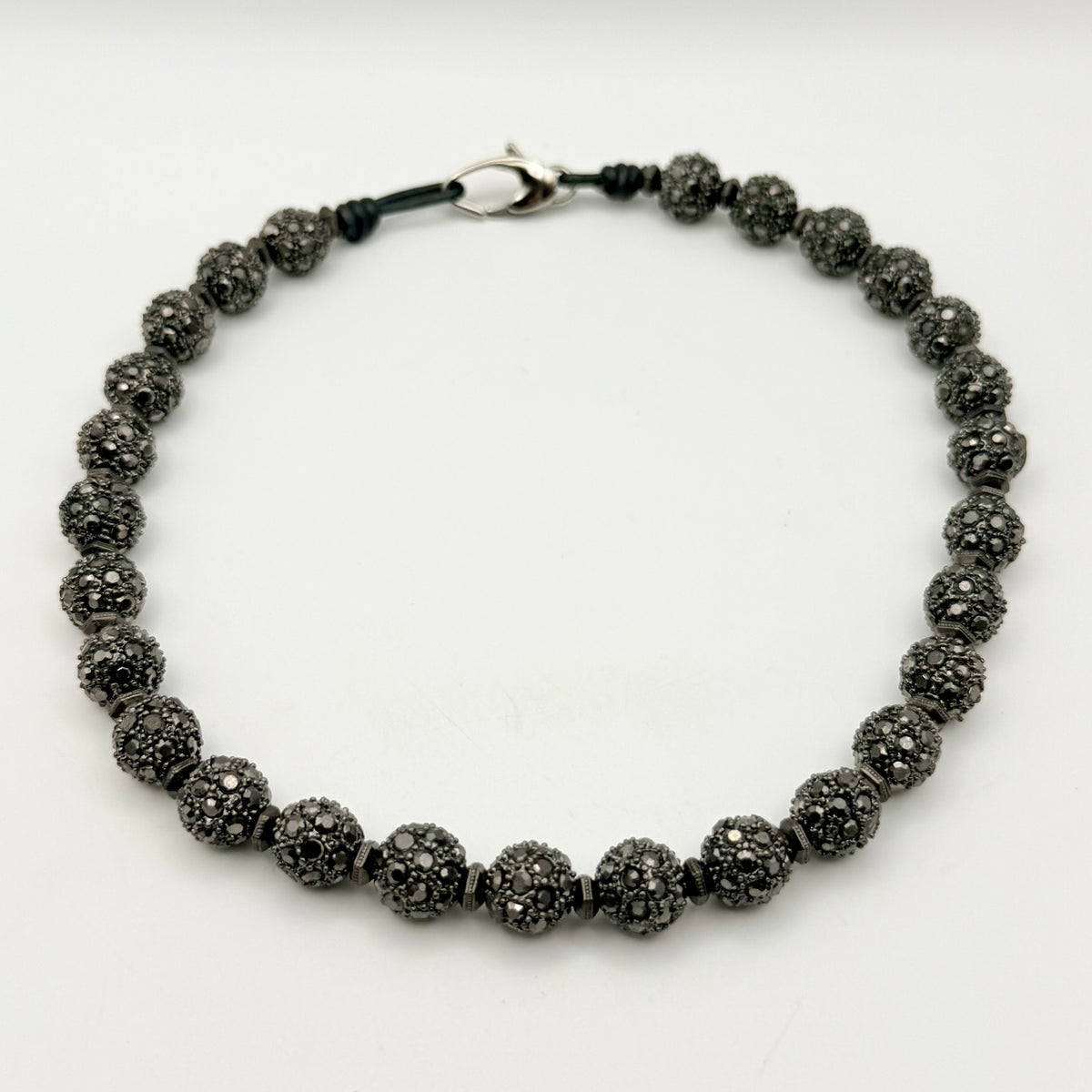 Black beaded necklace on a white background