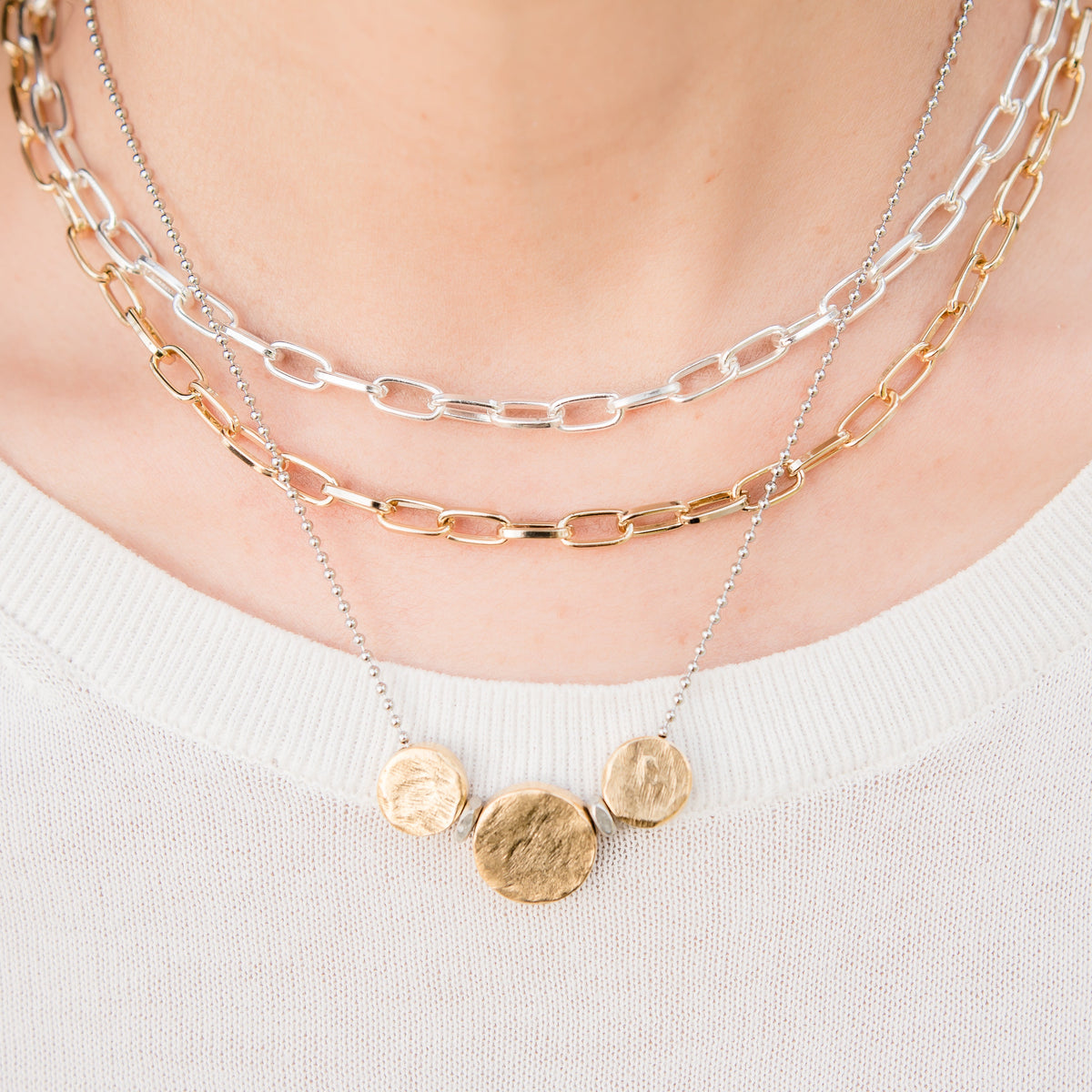 Necklace with gold pendants on a white background